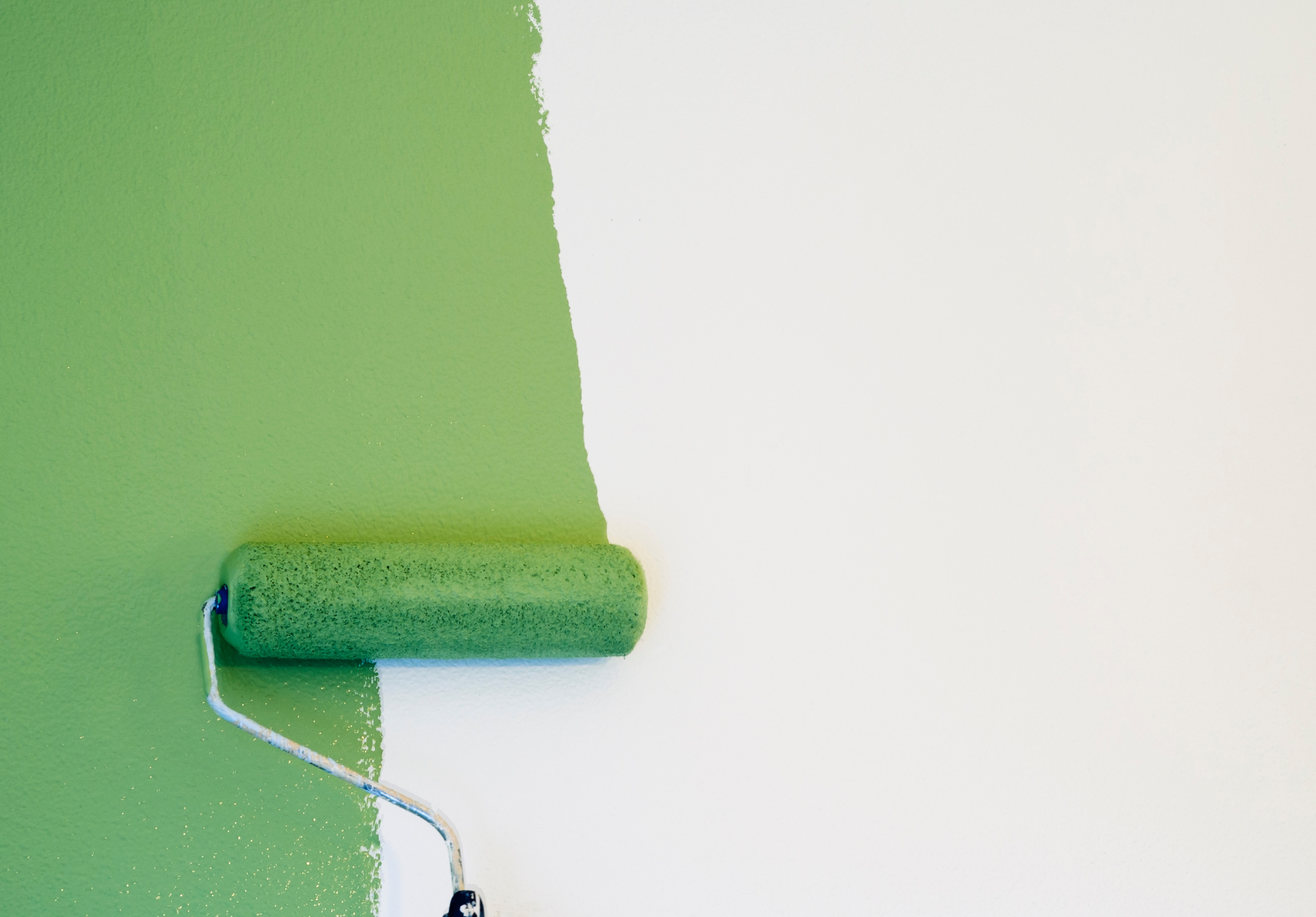 Paint Roller Painting a Wall